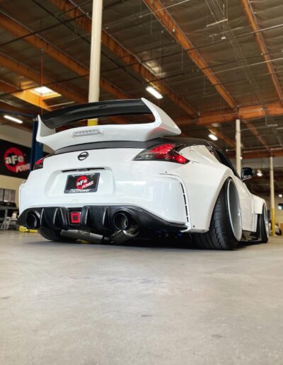 Back of white 2013 Nissan 370z with aFe Power performance parts