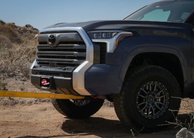 Grey 2022 Toyota Tundra in the desert towing from the front with aFe front tow hooks