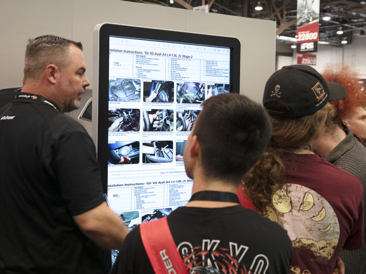 Man showing customers products on electronic kiosk at car show