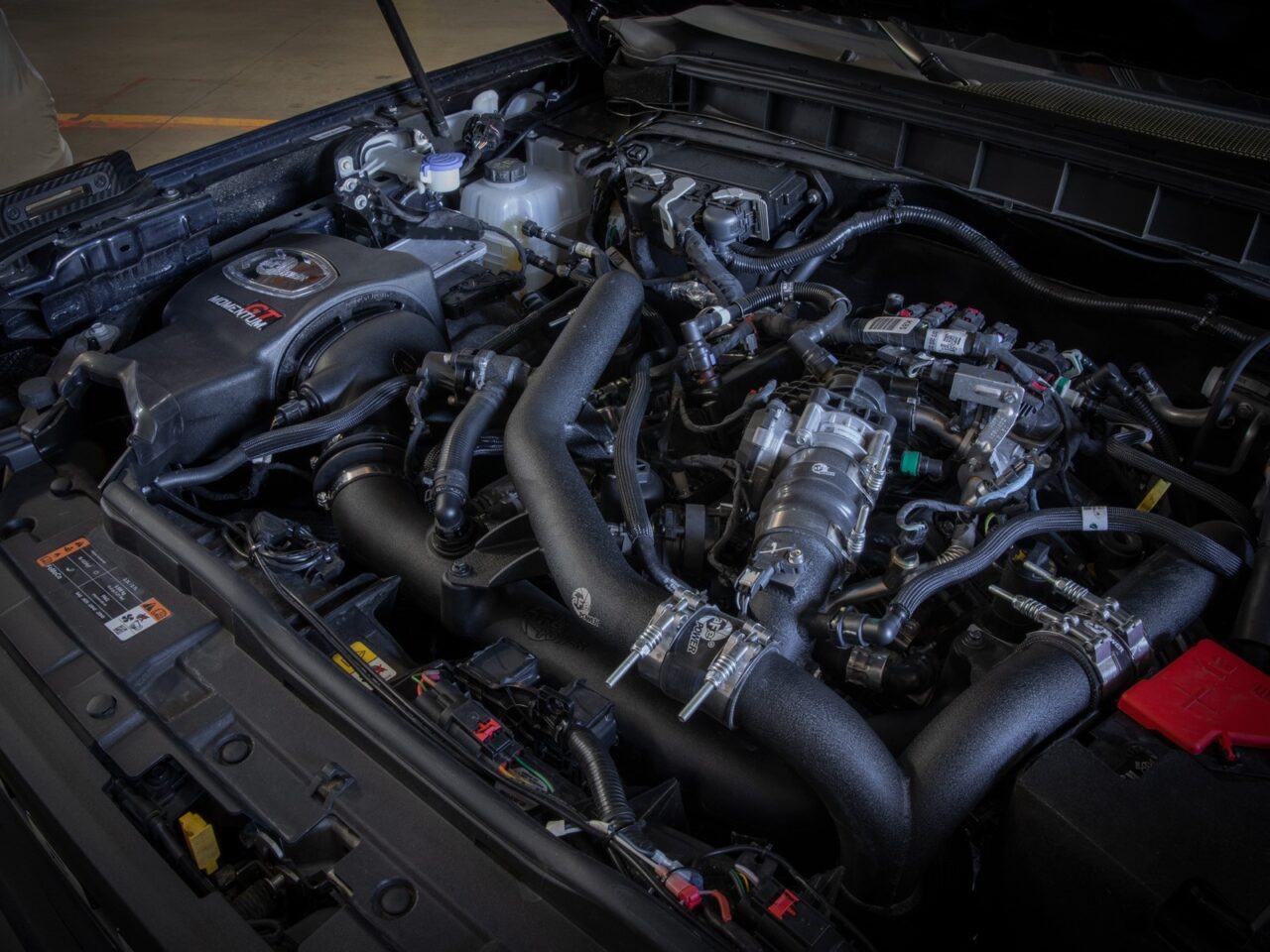 Aftermarket aFe cold air intake installed on 2022 Ford Bronco V6 engine under the hood