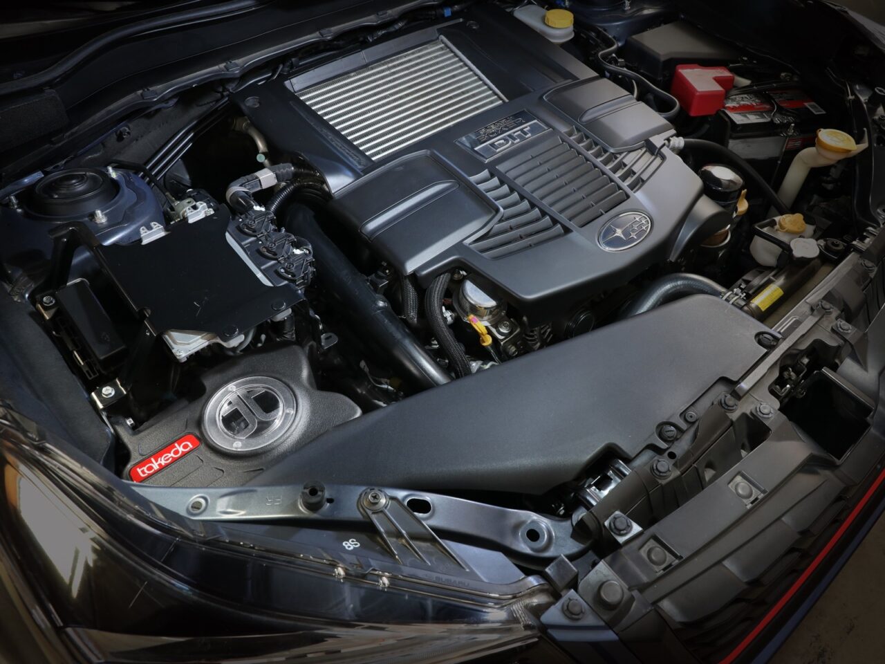 Under the hood view of aFe Takeda after-market intake system installed on 2018 Subaru Forester engine