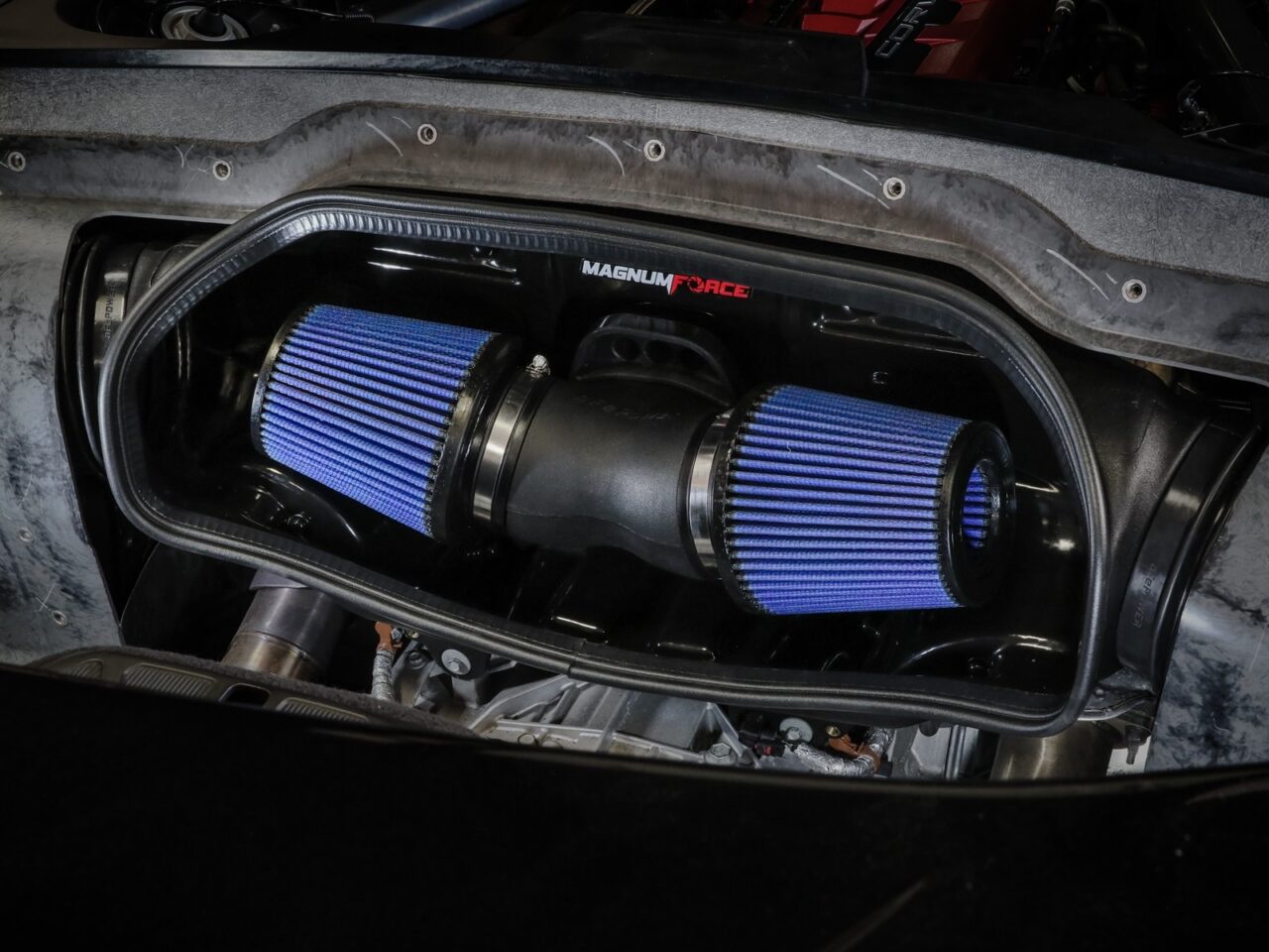 C8 mid-engine bay with aftermarket AFE Magnum Force cold air intake with two blue oiled performance cotton guaze filters 