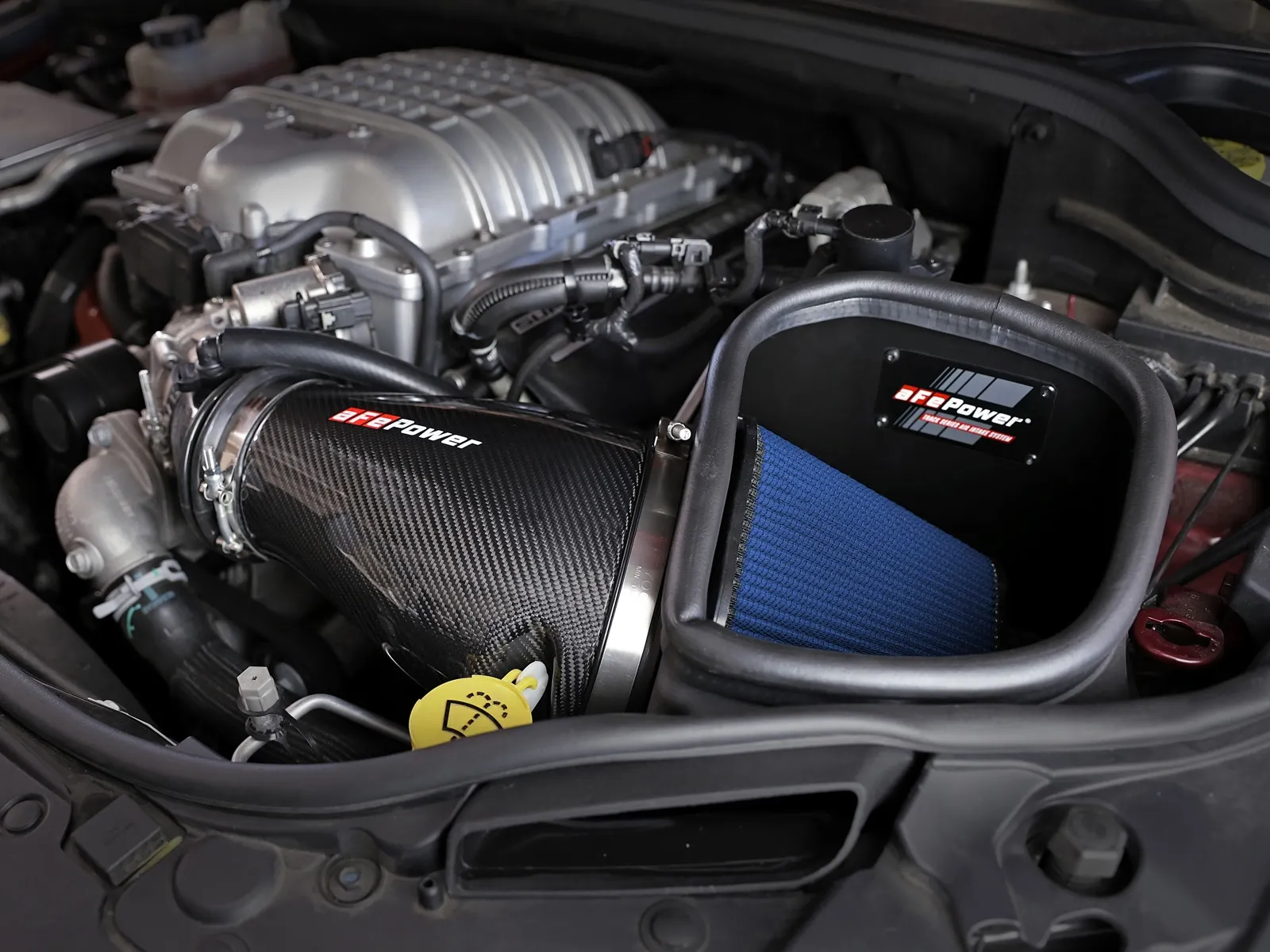 2019-2021 Jeep Grand Cherokee Trackhawk engine bay with aFe Track Series open-element Intake with Carbon Fiber tube and blue filter