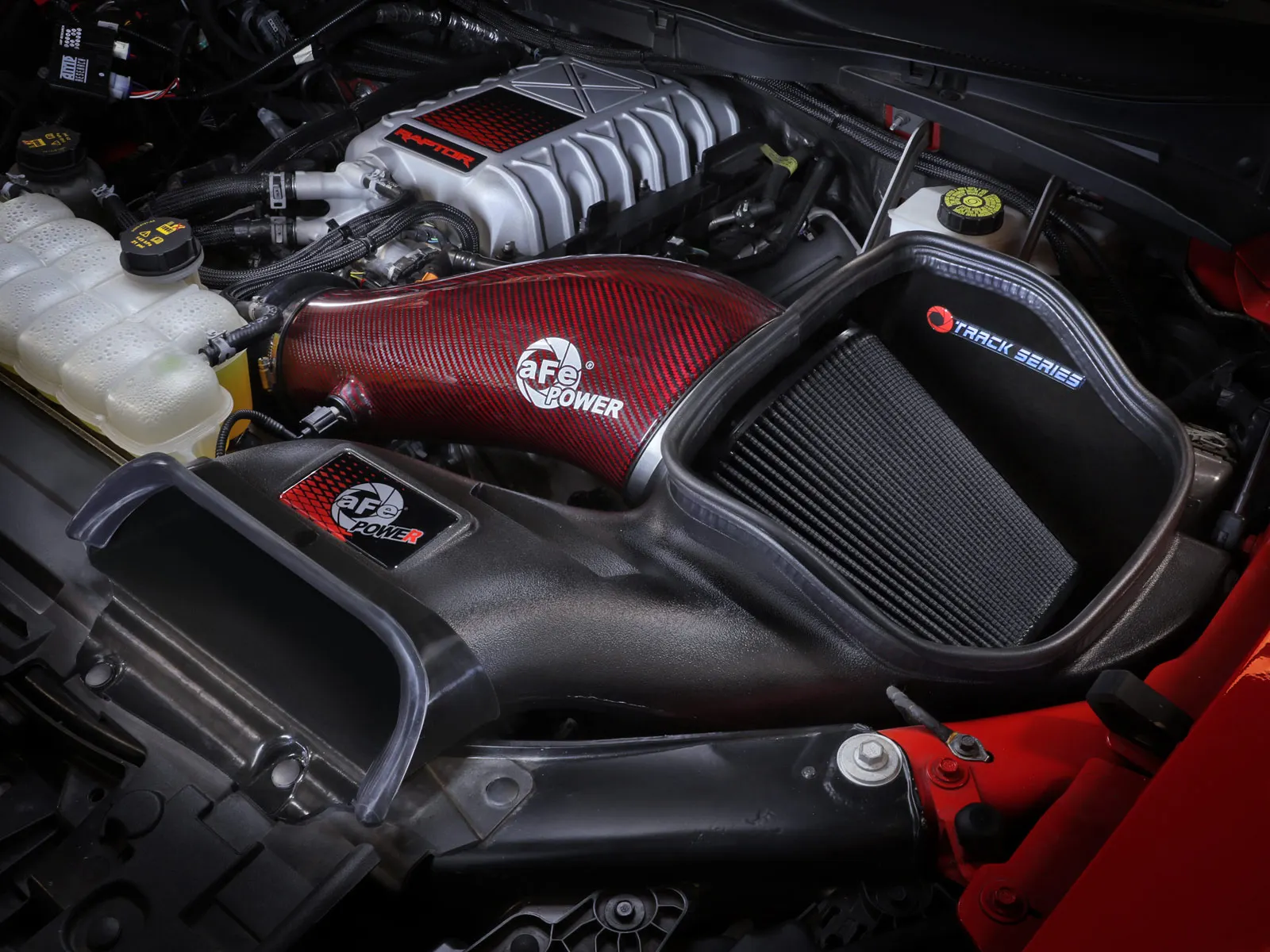 Red Kevlar Tube on aFe Track Series open intake with matching Raptor R red dot emblem on F-150 Raptor R
