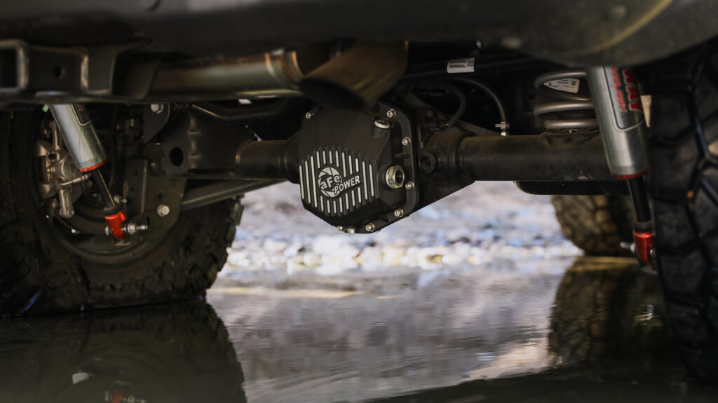 aFe Front and Rear Leveling kit on Red Toyota Sequoia TRD Pro side view showing level line in car shop 