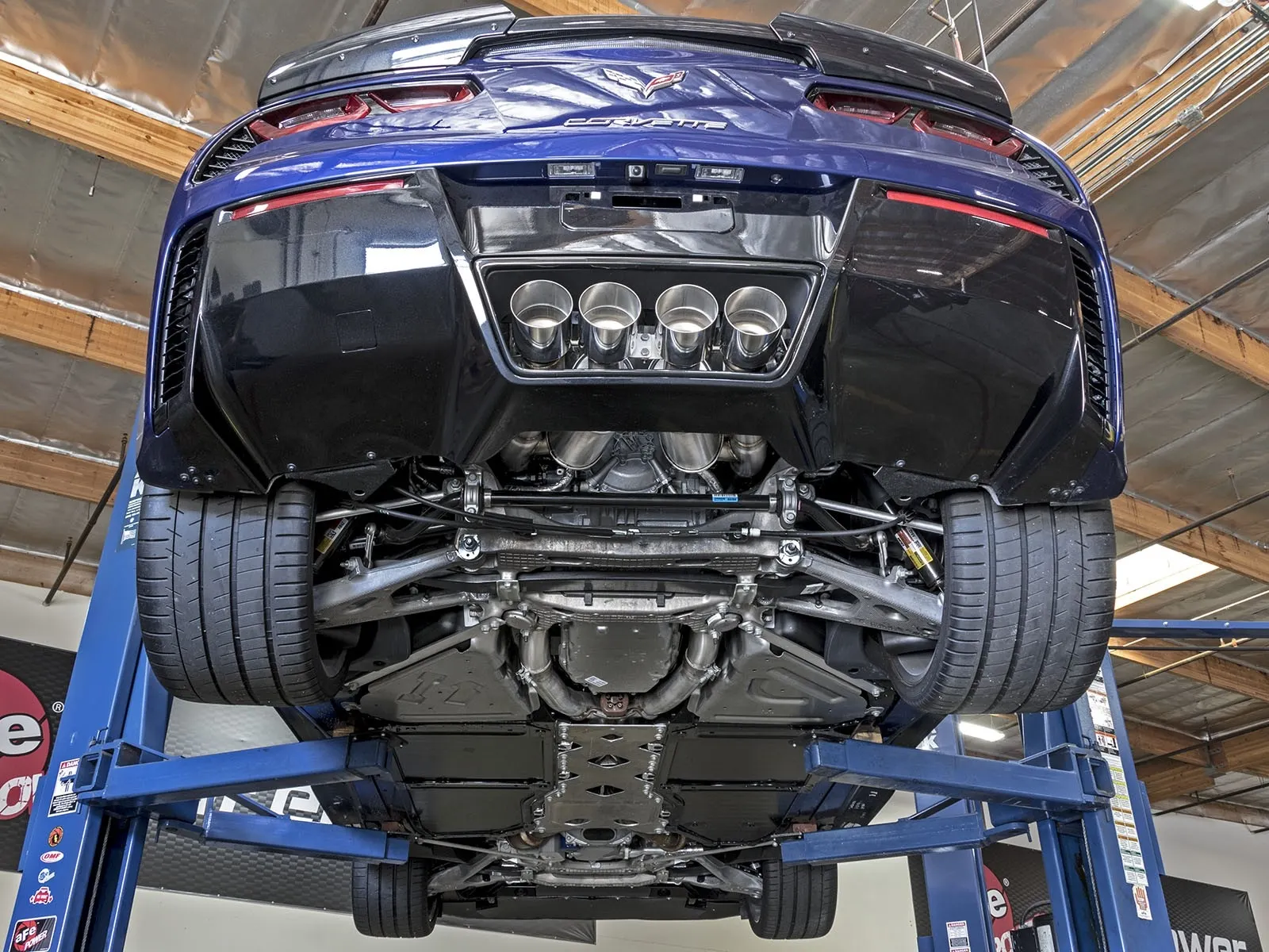 Blue Corvette C7 Z06 on lift with aFe quad tip axle-back exhaust sytsem