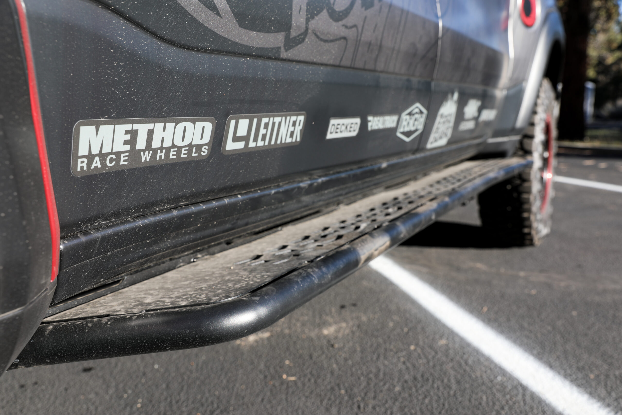 Close up of Dusty Rock slider steps on Ram RHO Overland build