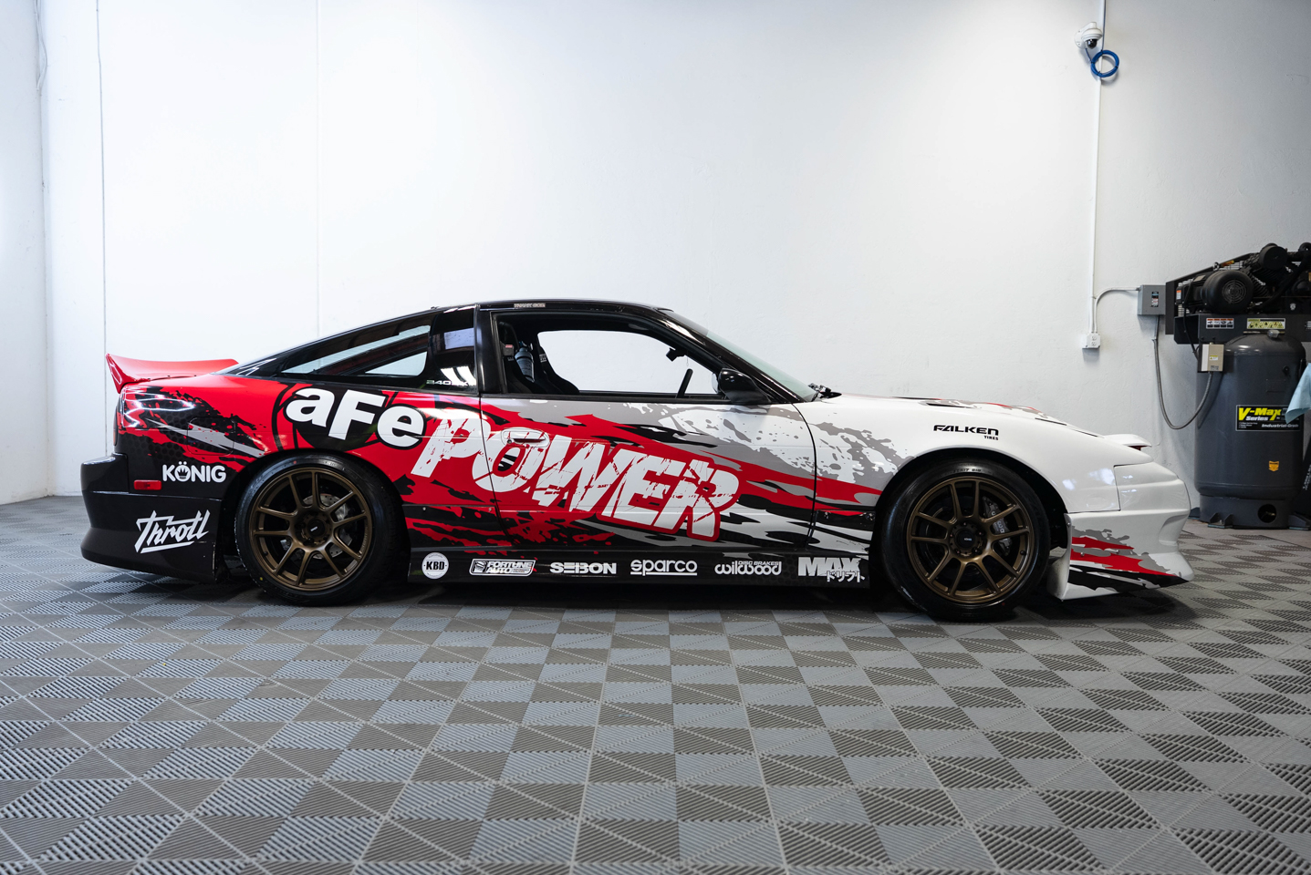 Side angle of Nissan 240SX with aFe wrap and KBD body kit