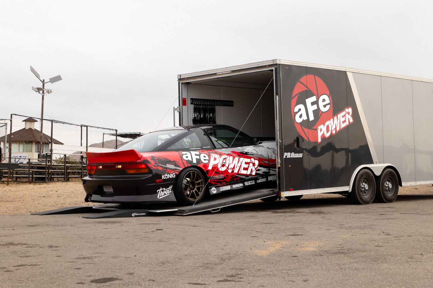 Nissan 240SX drift car loading up into aFe POWER trailer at racetrack