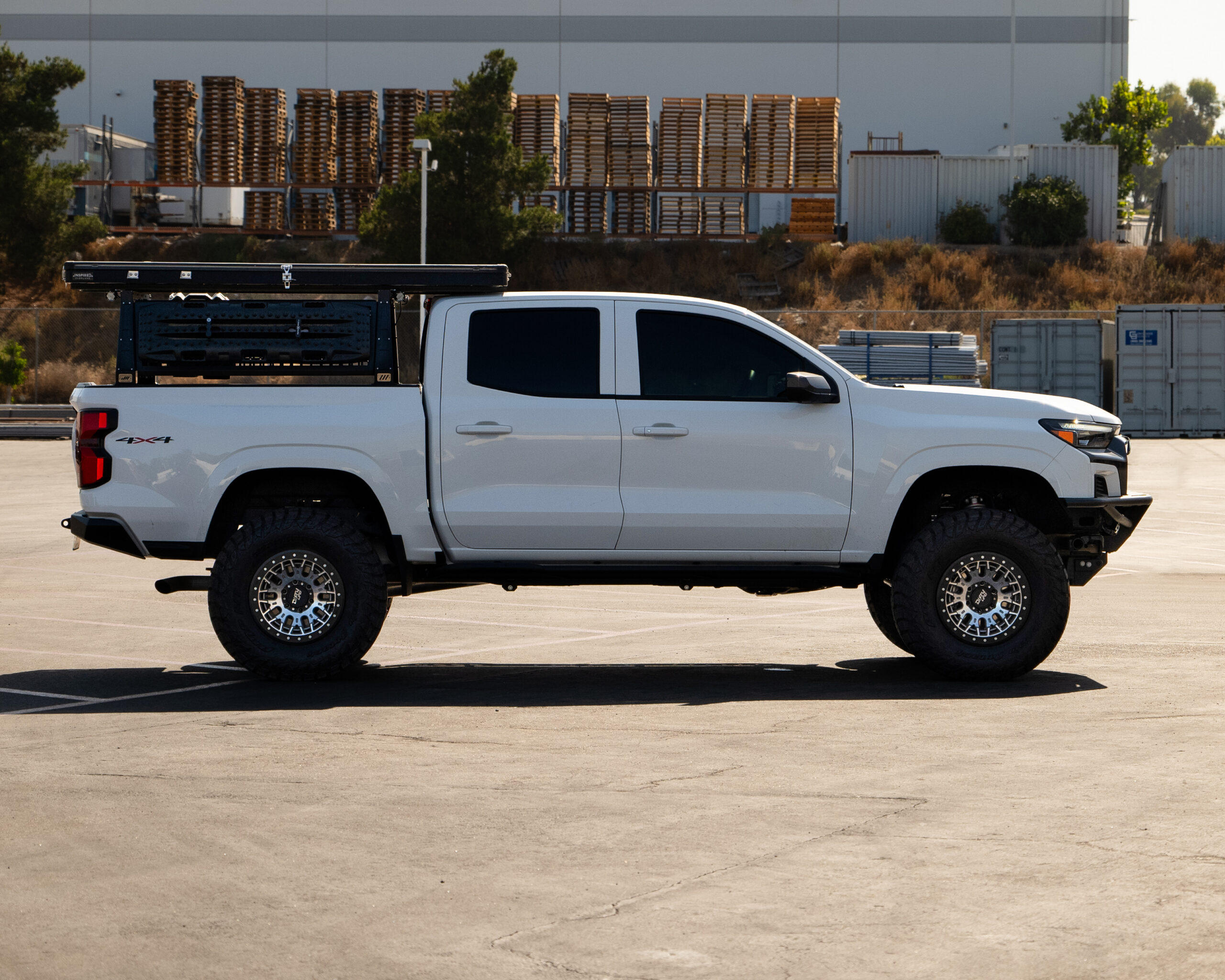 Side view of white Chevy Colorado on 35