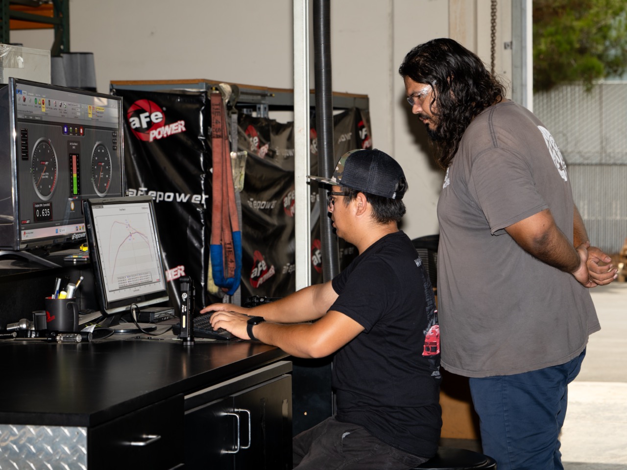 Dyno techs looking at computer screens of gauges of Dyno and torque/horsepower readings